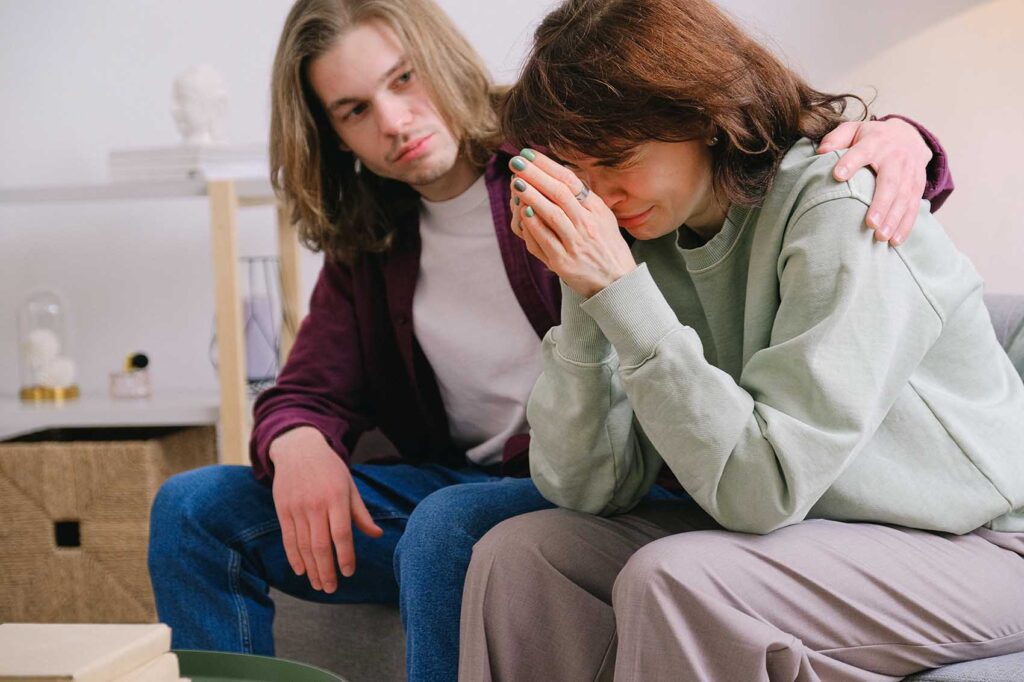 Man consoling his wife in distress over impending foreclosure